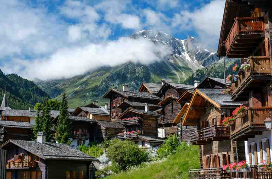 How Much Does a Switzerland Affordable Trip Cost from India for a Single Person in 2026? Traditional sun-blackened wooden chalets in Grimentz, Switzerland Affordable Trip Cost from India for Single Person
