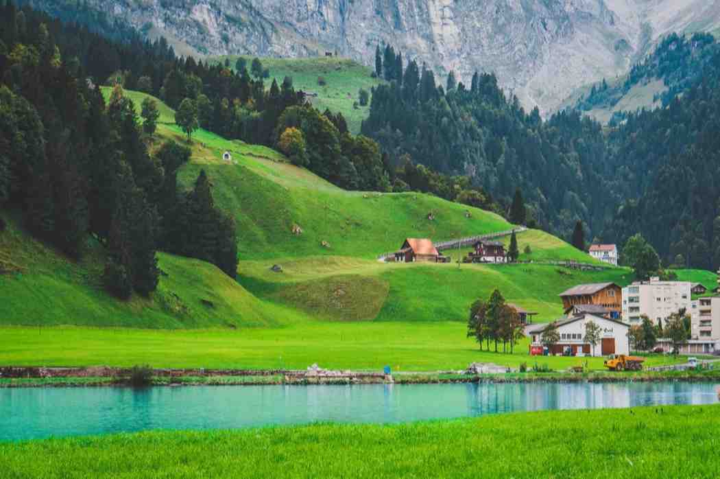 When Is the Best Time to Visit Switzerland in Summer? Vibrant turquoise waters of Lake Brienz in Iseltwald, showcasing the ideal scenery found when traveling during the best time to visit Switzerland in summer