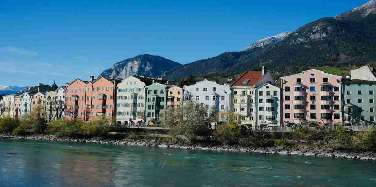 10 Best Tourist Attractions in Austria — A Local's Complete Guide 2026 Colorful historic buildings in Innsbruck Old Town surrounded by the Alps, one of the best tourist attractions in Austria
